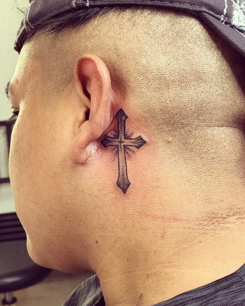 Bold Gothic Cross Behind the Ear Tattoo Design