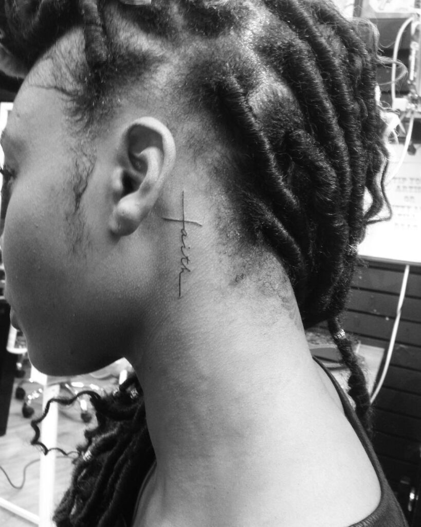 Delicate Vertical "Faith" Script Behind the Ear Tattoo Design