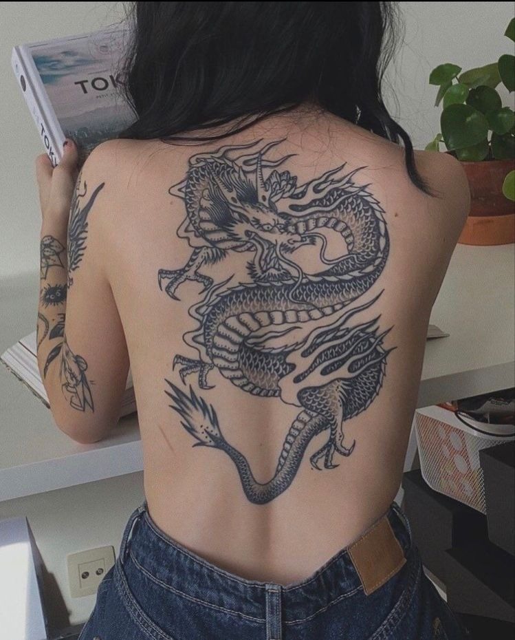 Classic Black Traditional Dragon for Women, a tattoo design rendered in bold traditional for the back.