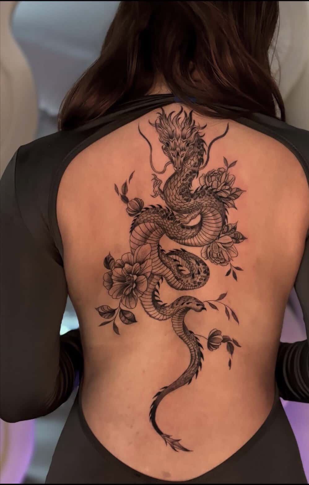 Feminine Dragon Spine Design with Flowers, a tattoo design rendered in delicate fine-line for the back.