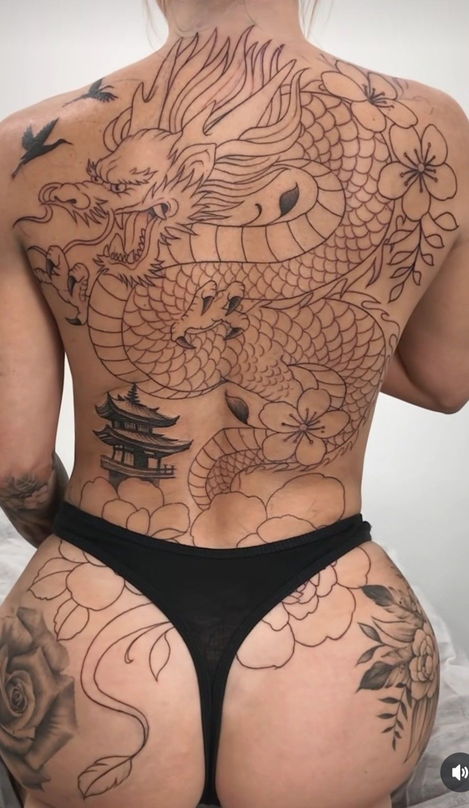 Japanese Dragon with Flowers and Temple Detail, a tattoo design rendered in bold traditional.