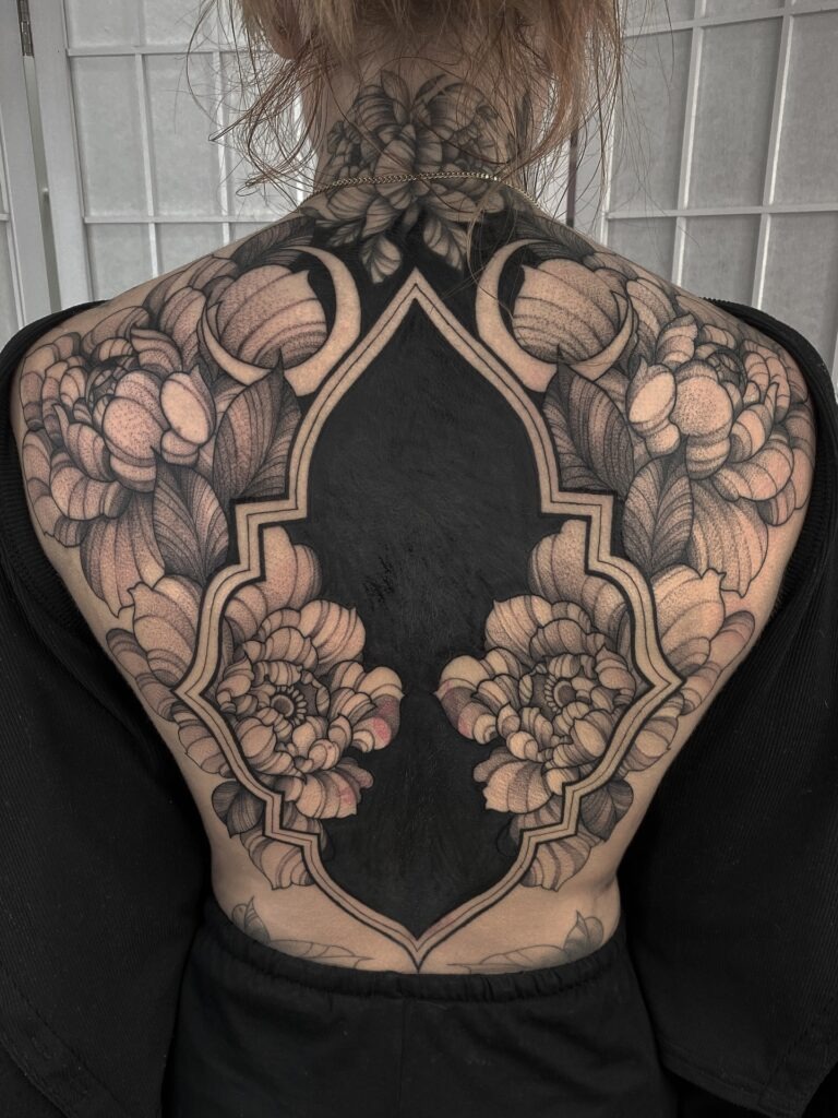 Bold Blackwork Back Tattoo with Florals and Geometric Frame Tattoo Design
