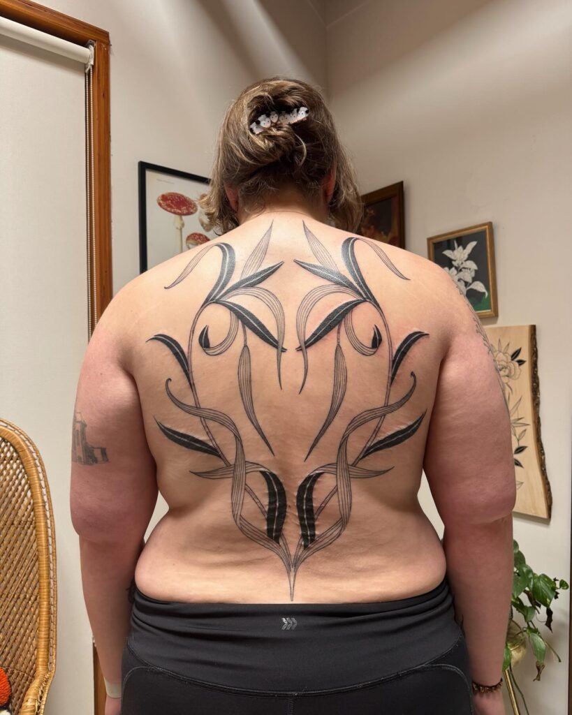 Bold Flowing Linework with Botanical Inspiration Tattoo Design