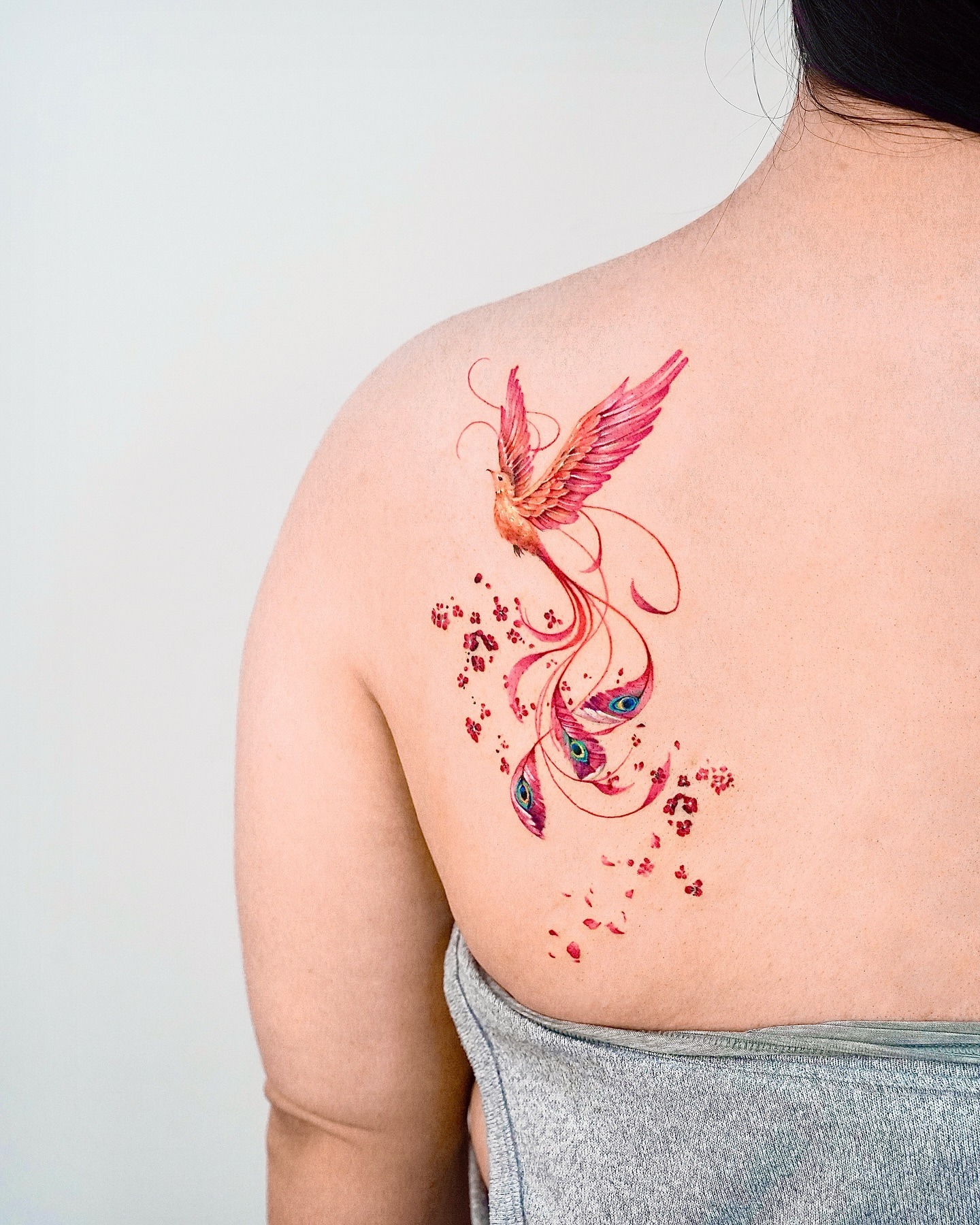Elegant Phoenix Back Tattoo with Flowing Feathers Tattoo Design