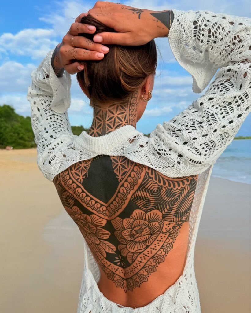 Geometric Blackwork Back Tattoo with Floral Accents Tattoo Design