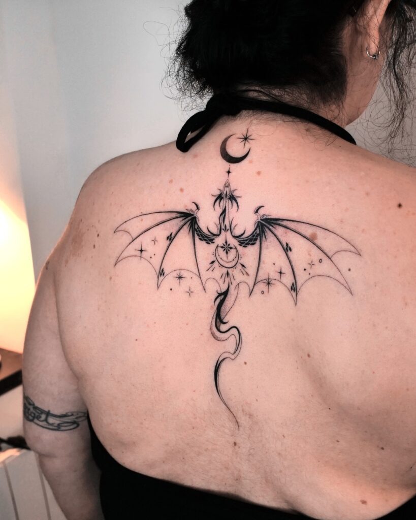 Ornamental Dragon Back Tattoo with Celestial Accents Tattoo Design