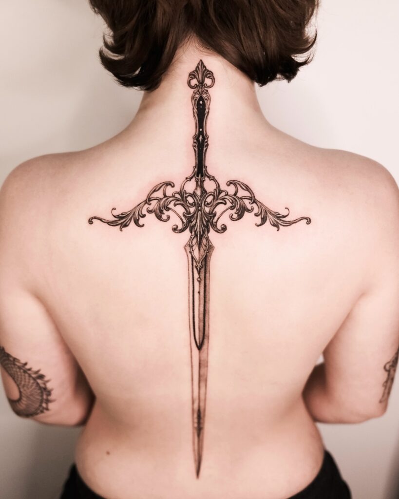 Ornamental Sword Spine Tattoo with Elegant Scrollwork Tattoo Design