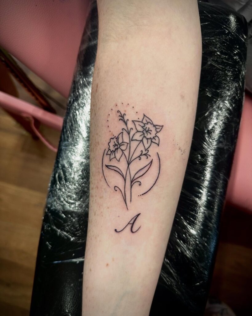 Daffodil Fine Line Tattoo with Initial Tattoo Design