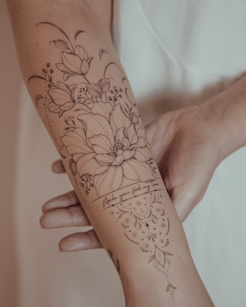Floral Forearm Tattoo with Script and Ornamental Details Tattoo Design