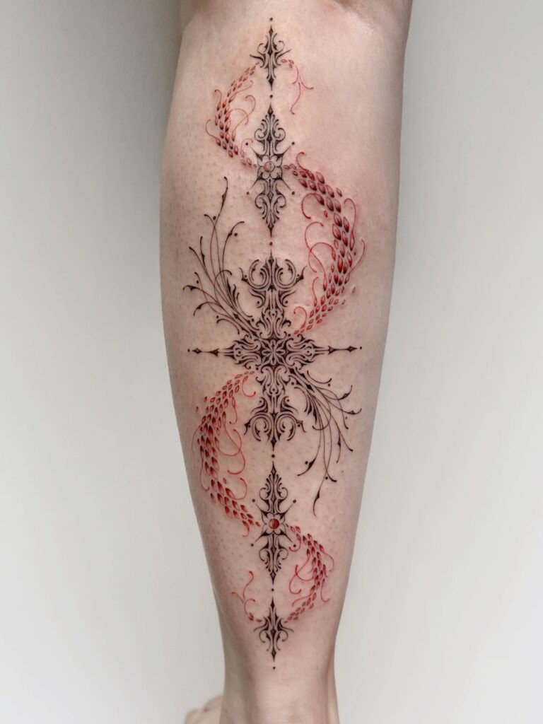 Ornamental Fine Line Tattoo with Red Accents Tattoo Design