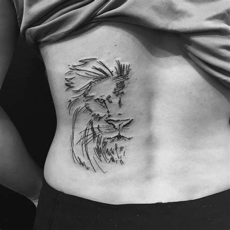 Regal Simplicity: Crowned Lion Finger Tattoo Tattoo Design