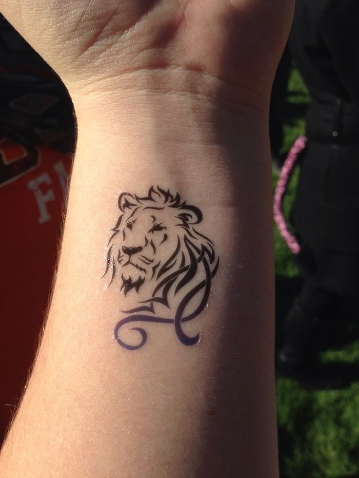 Tribal Influence: The Lion and Scroll Tattoo Design