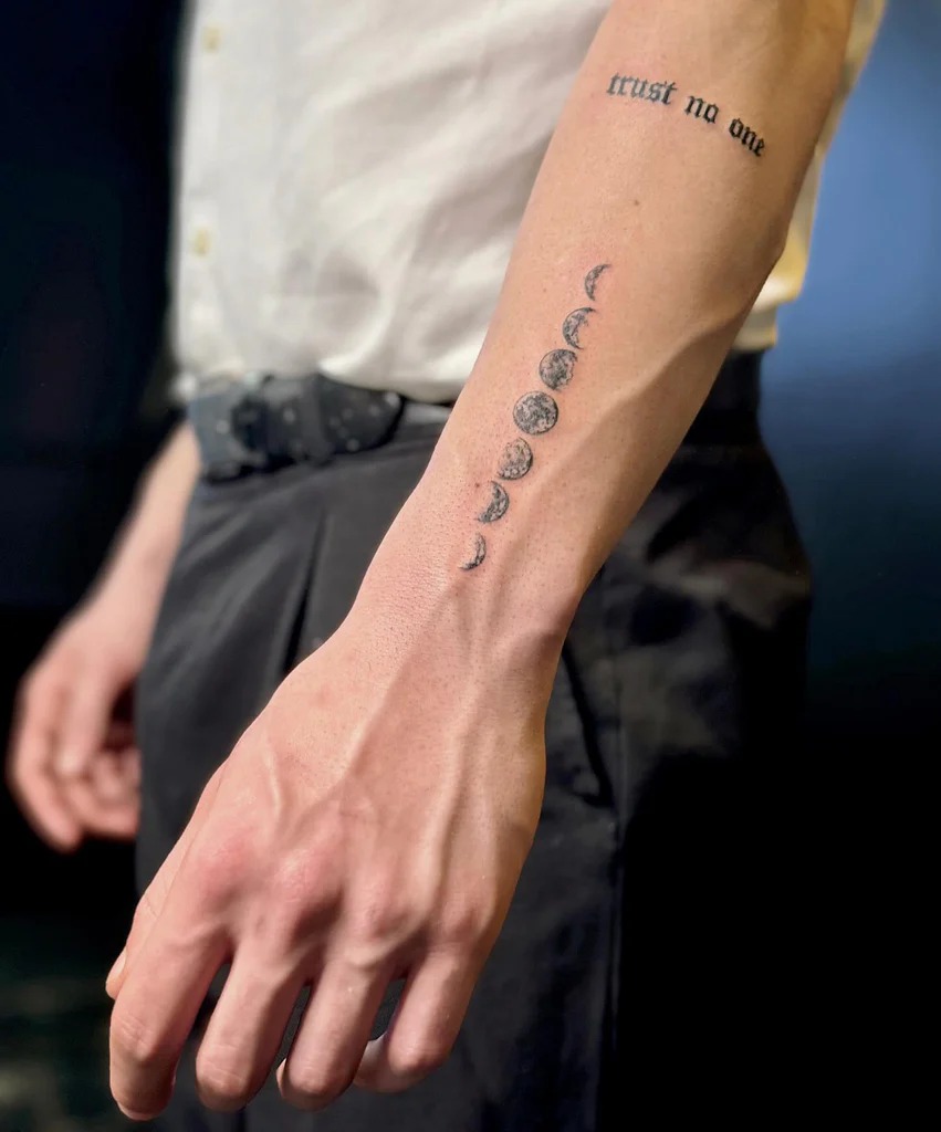 Phases of the Moon and "Trust No One" on Forearm Tattoo Design