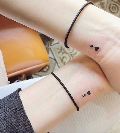 This design features a semicolon paired with a small heart, symbolizing both self-love and resilience.