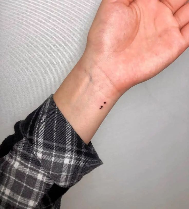 A tiny semicolon tattoo on the wrist or mini finger placement creates a subtle yet meaningful design.