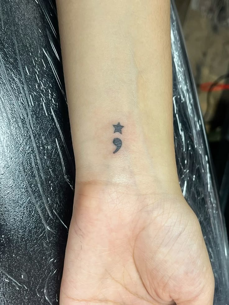 This simple yet powerful design features a tiny star above a semicolon, symbolizing guidance, hope, and inner light.