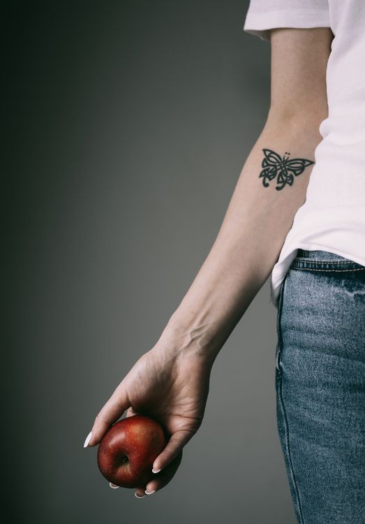 Butterfly tattoo on a forearm