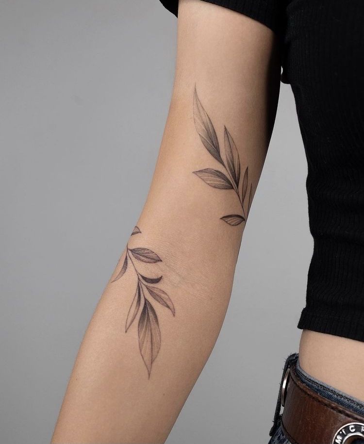 Leaf branch tattoo on an arm