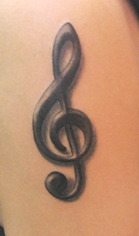 Treble clef music tattoo