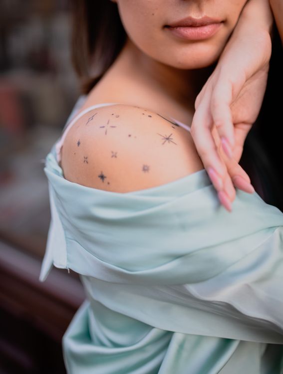 Tiny star tattoos on a shoulder