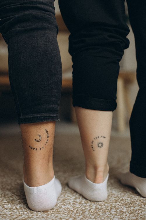 Matching tiny sun and moon tattoos on ankles