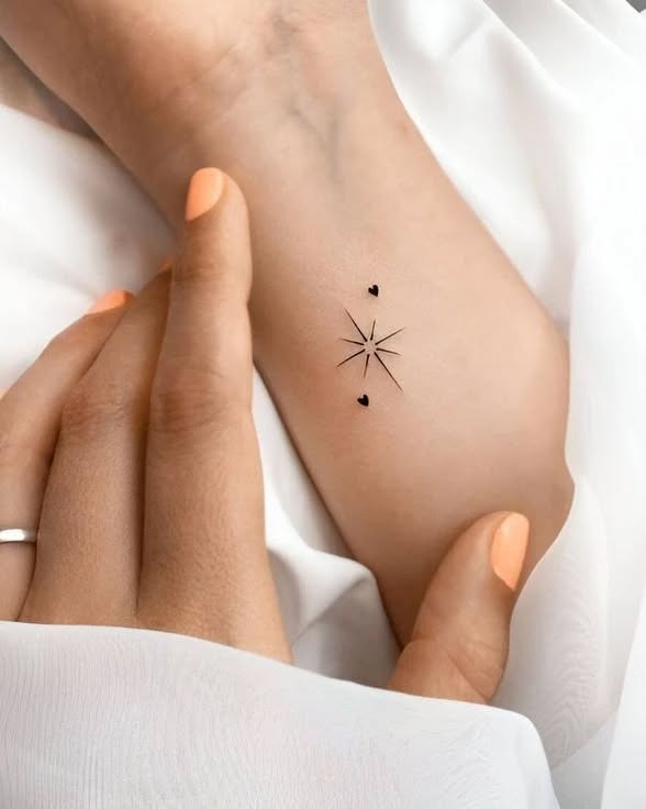 Tiny Starburst and Hearts Wrist Tattoo Tattoo Design