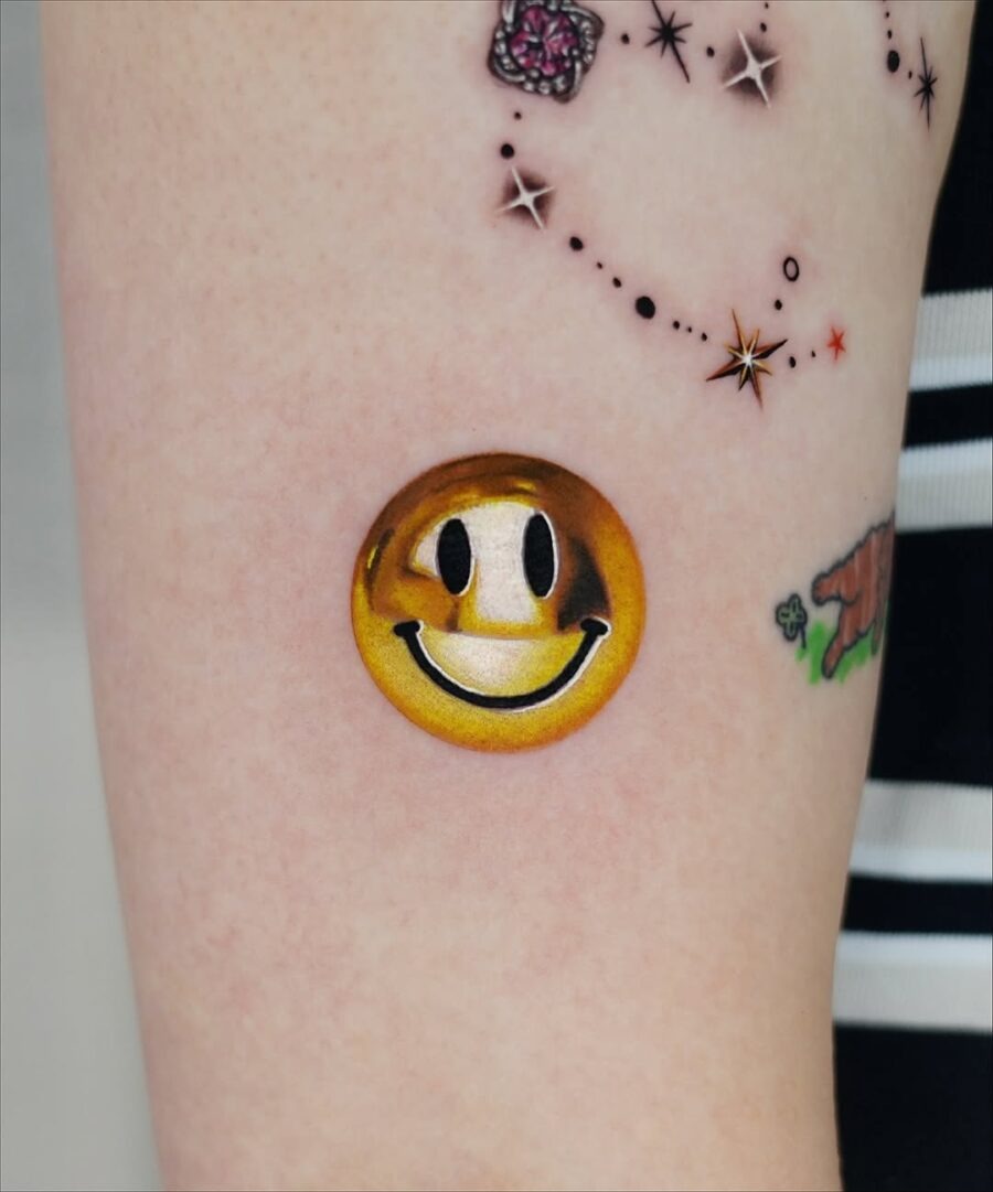 Charming golden smiley face tattoo inspiration Tattoo Design