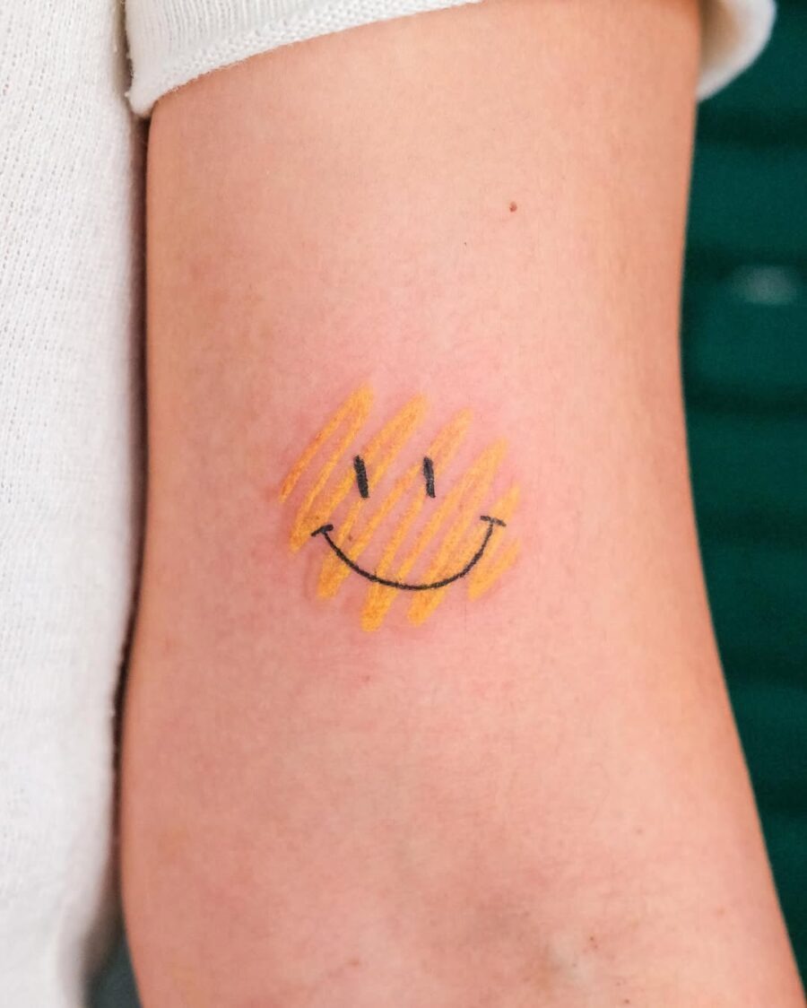 Charming smiley tattoo with warm yellow stripes Tattoo Design