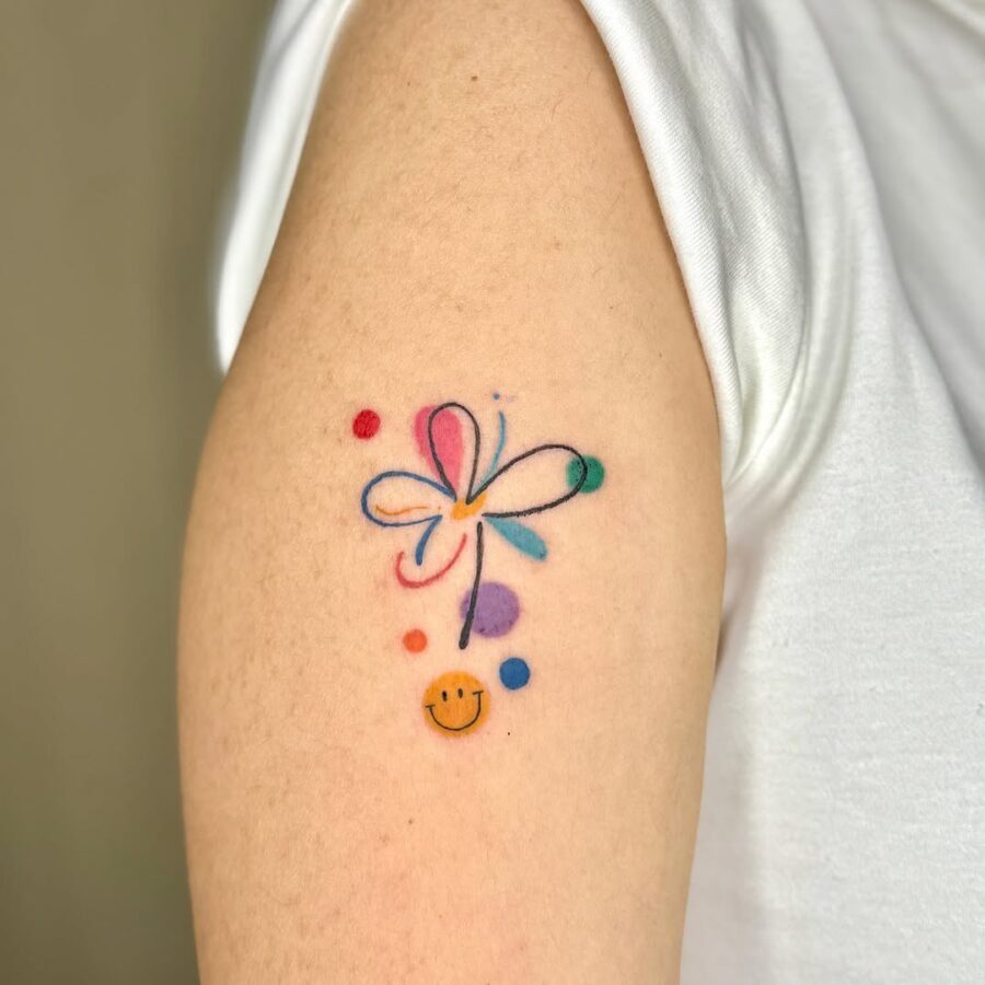Colorful smiley face tattoo with flower design Tattoo Design