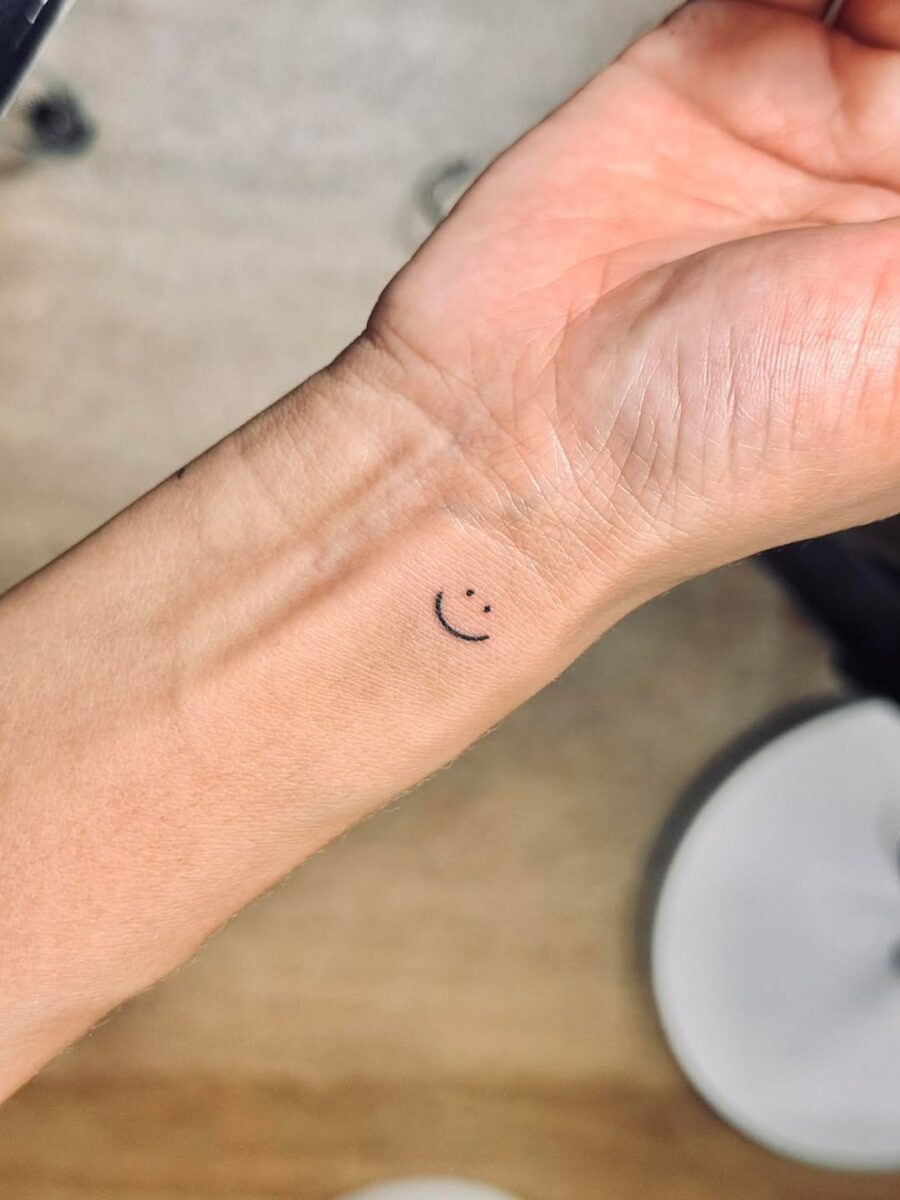 Minimalistic smiley face tattoo on wrist Tattoo Design