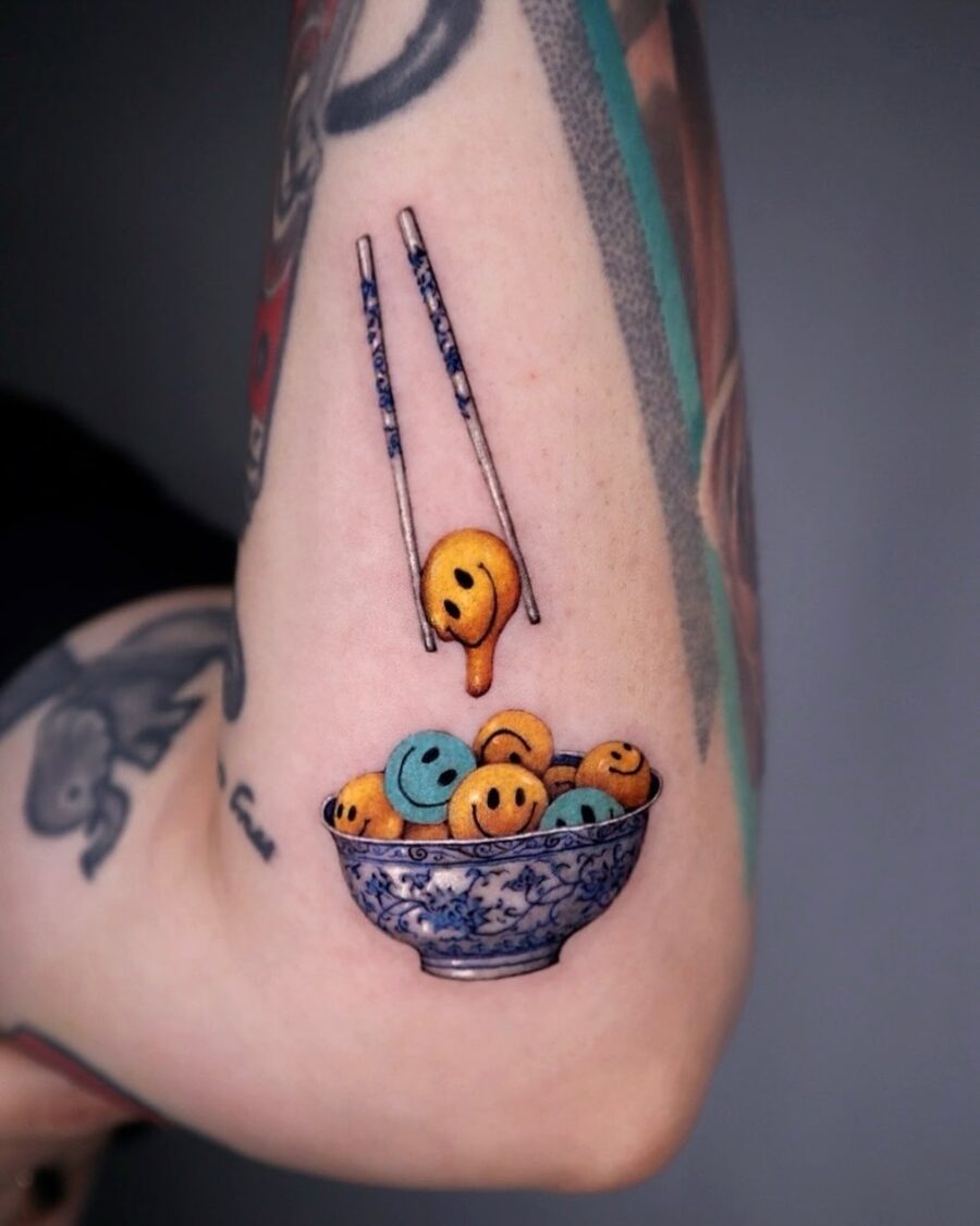 Playful smiley face tattoo with artistic flair Tattoo Design