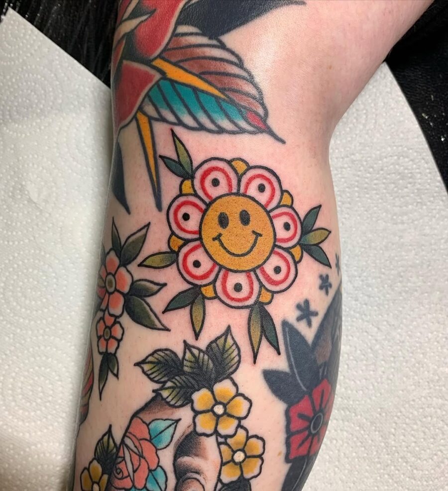 Playful Smiley Flower Design in Vibrant Colors Tattoo Design