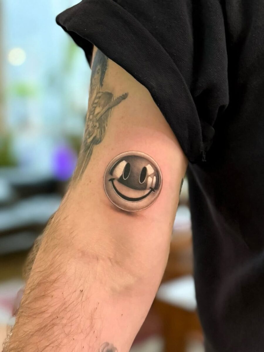 Realistic Smiley Face Tattoo on Arm Tattoo Design