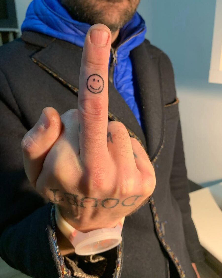 Unique smiley face tattoo on a finger Tattoo Design