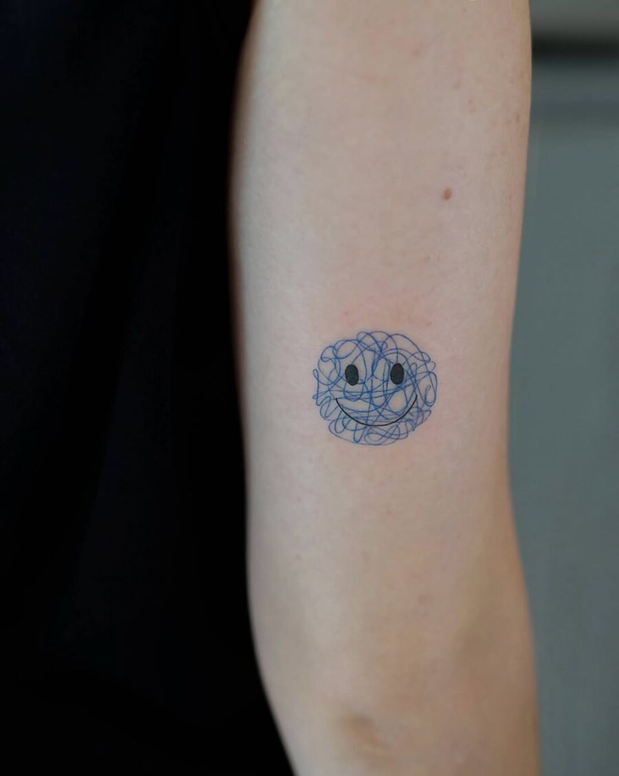 Unique Smiley Face Tattoo with Abstract Swirls Tattoo Design