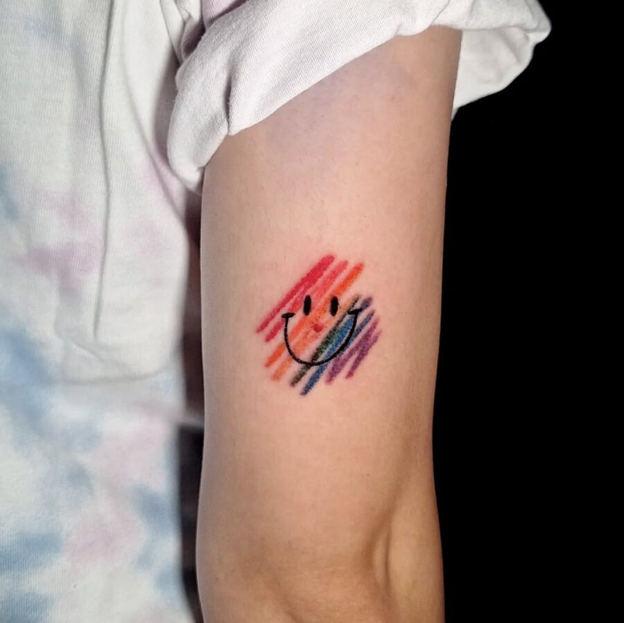 Vibrant Smiley Face Tattoo with a Colorful Splash Tattoo Design