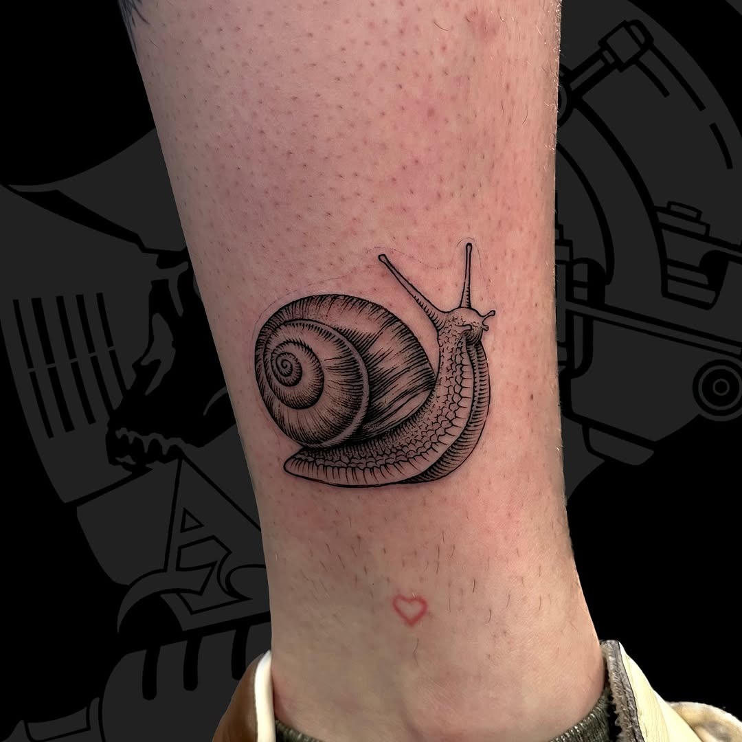 A unique black snail tattoo for enthusiasts Tattoo Design