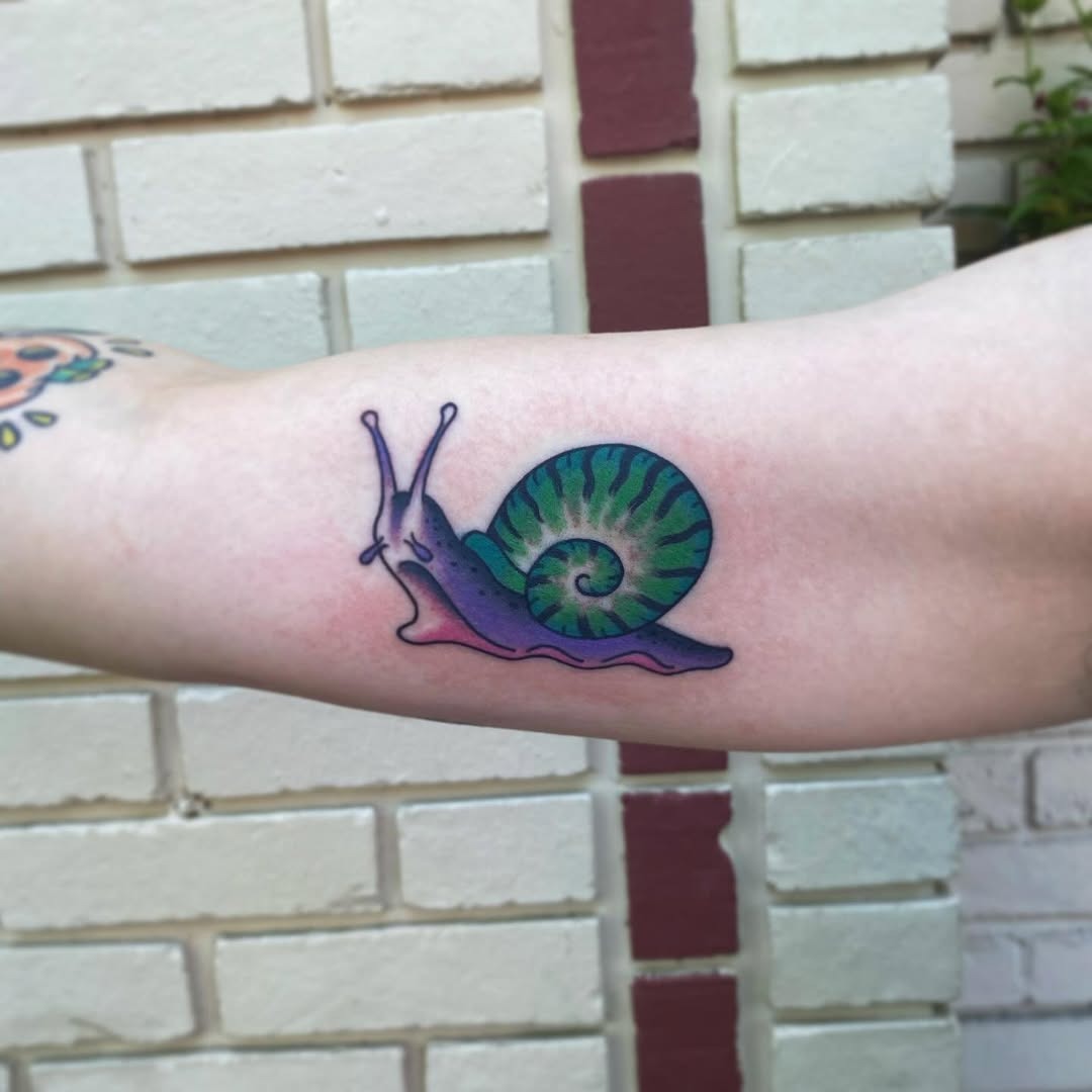 A Vibrant Snail Tattoo on Display Tattoo Design