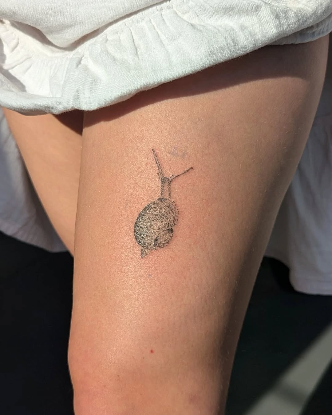 Charming Minimalist Snail Tattoo on Thigh Tattoo Design