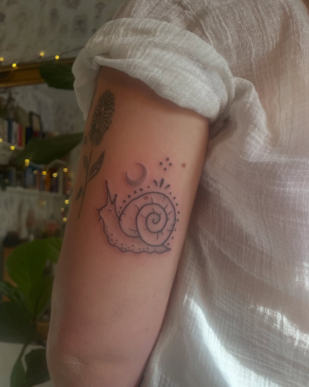 Charming snail tattoo with floral accents Tattoo Design