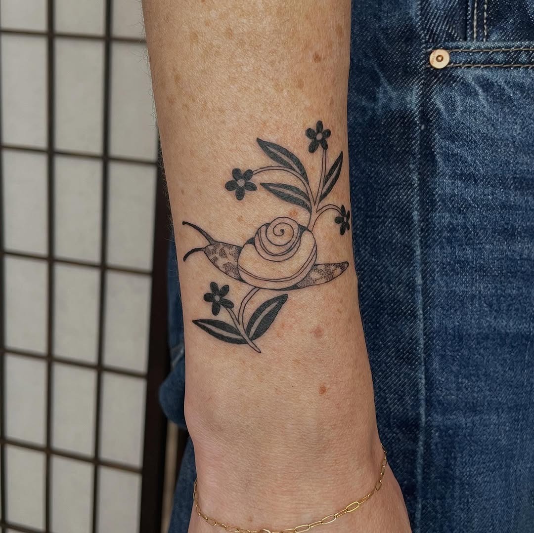 Charming snail tattoo with floral elements Tattoo Design