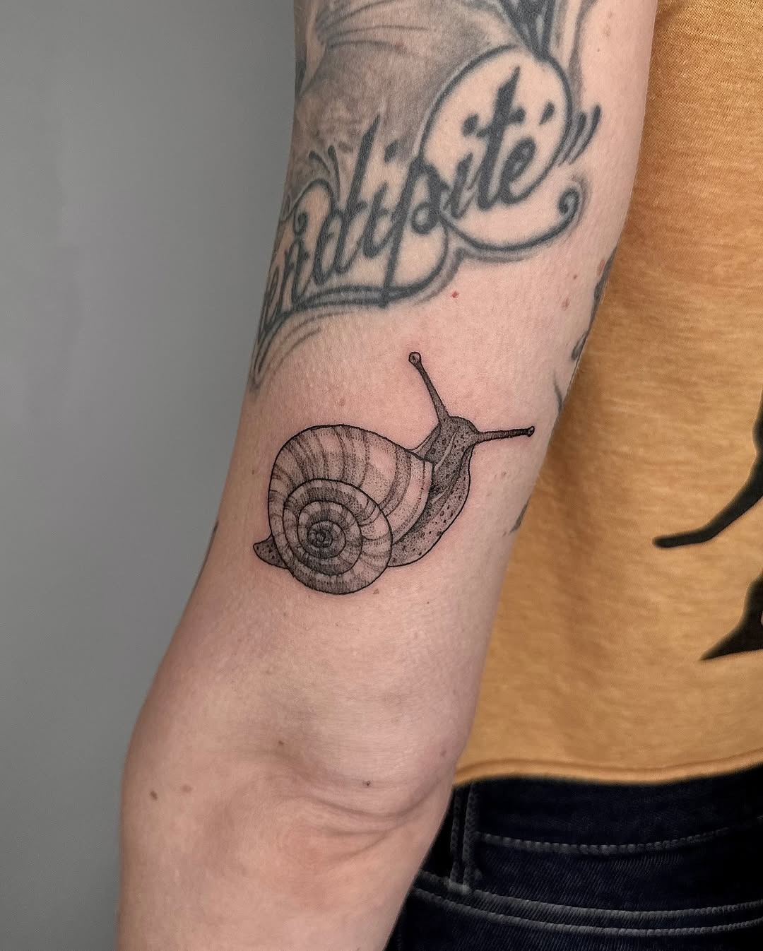 Charming snail tattoo with intricate detailing Tattoo Design