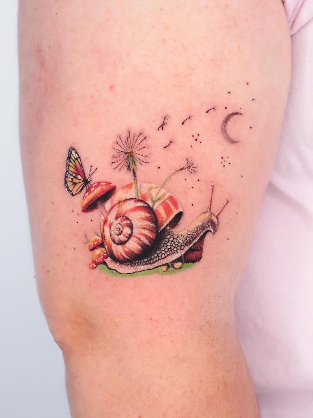 Charming snail tattoo with whimsical elements Tattoo Design