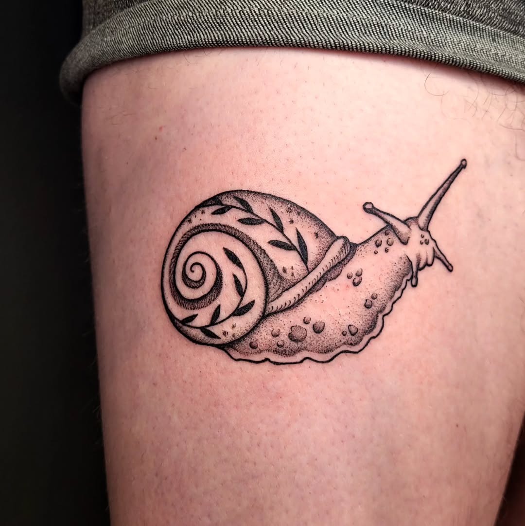 Elegant snail tattoo showcasing nature's beauty Tattoo Design