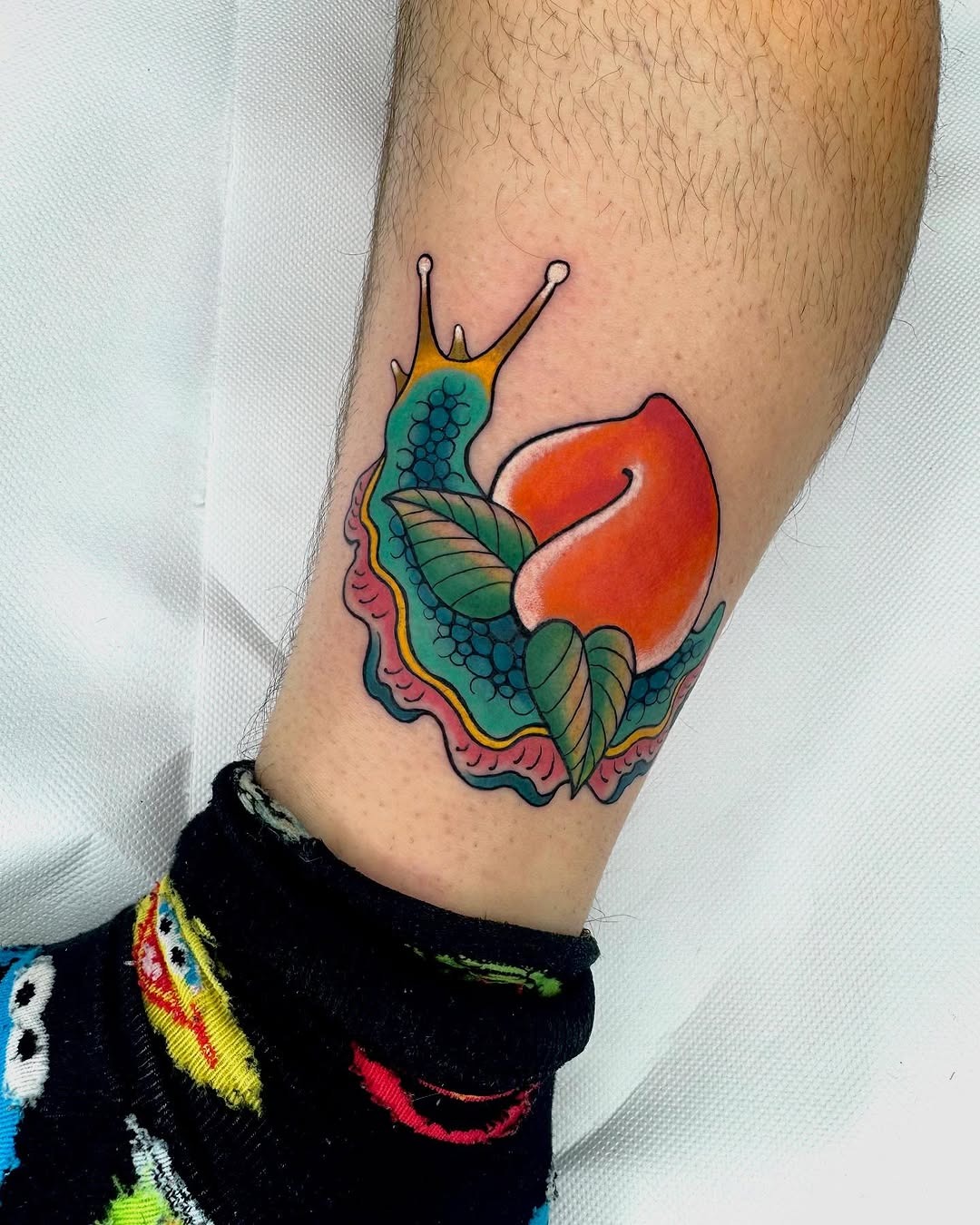 Vibrant snail tattoo with a peach design Tattoo Design