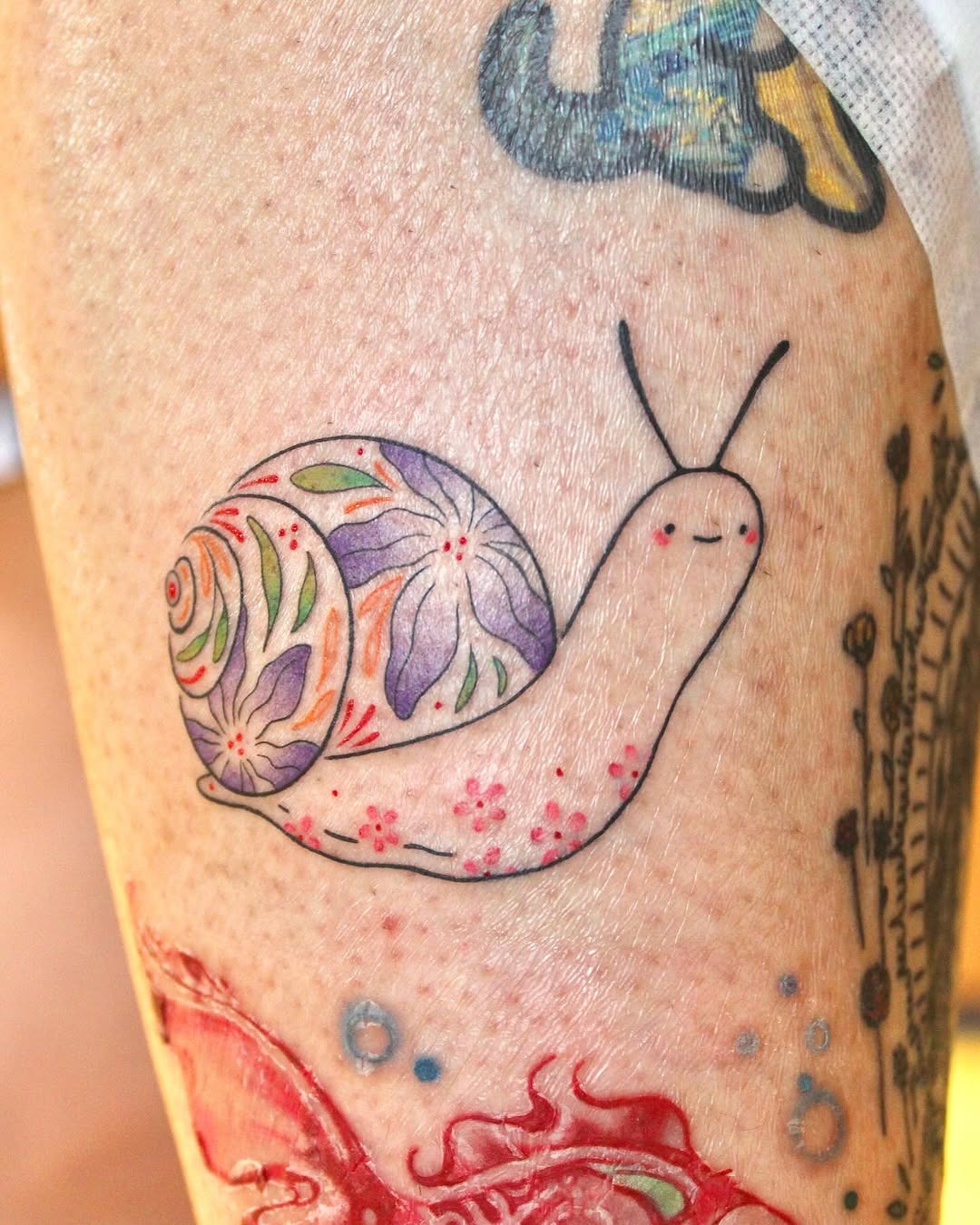 Whimsical Snail Tattoo with Floral Patterns Tattoo Design