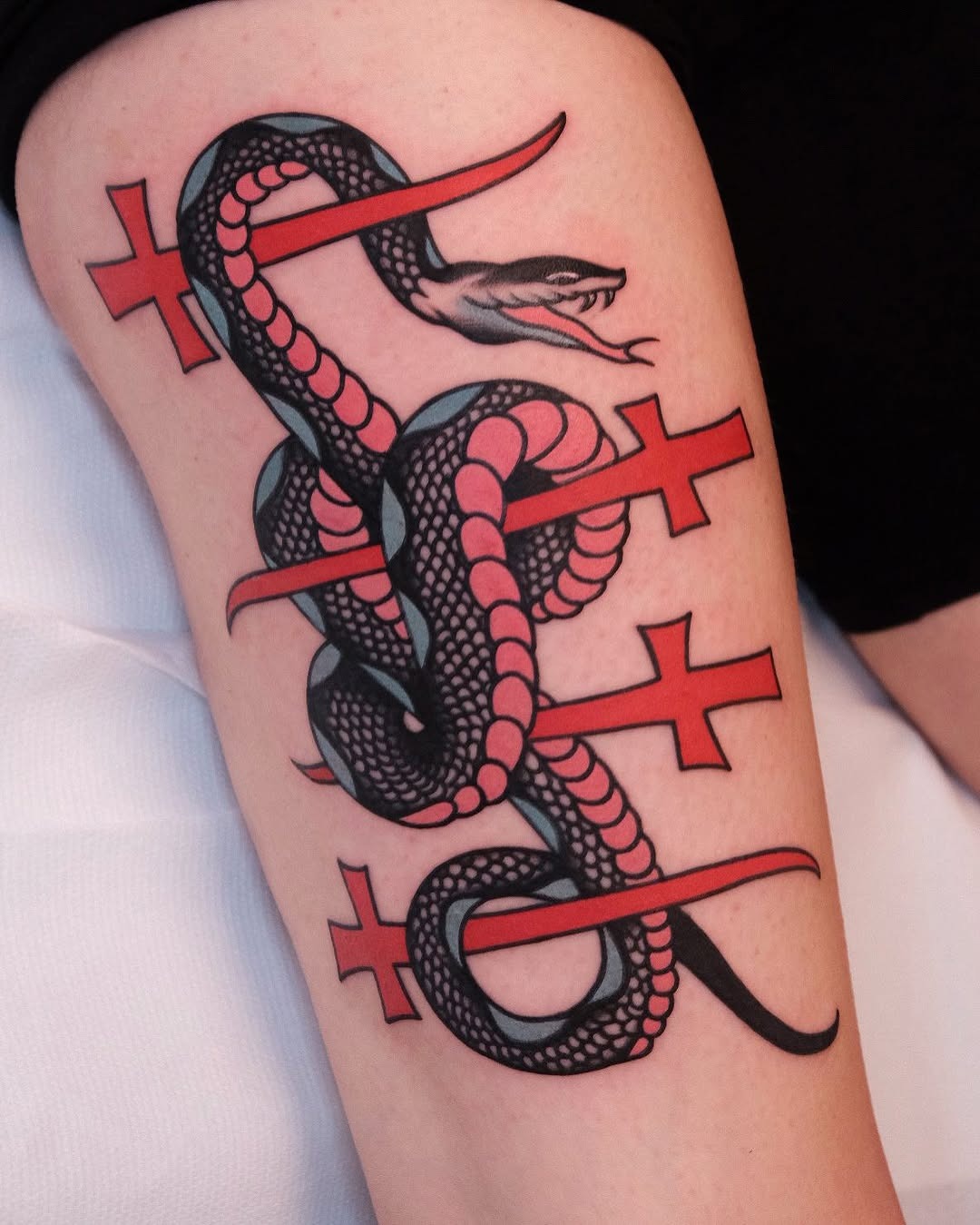 Bold snake tattoo intertwined with crosses Tattoo Design