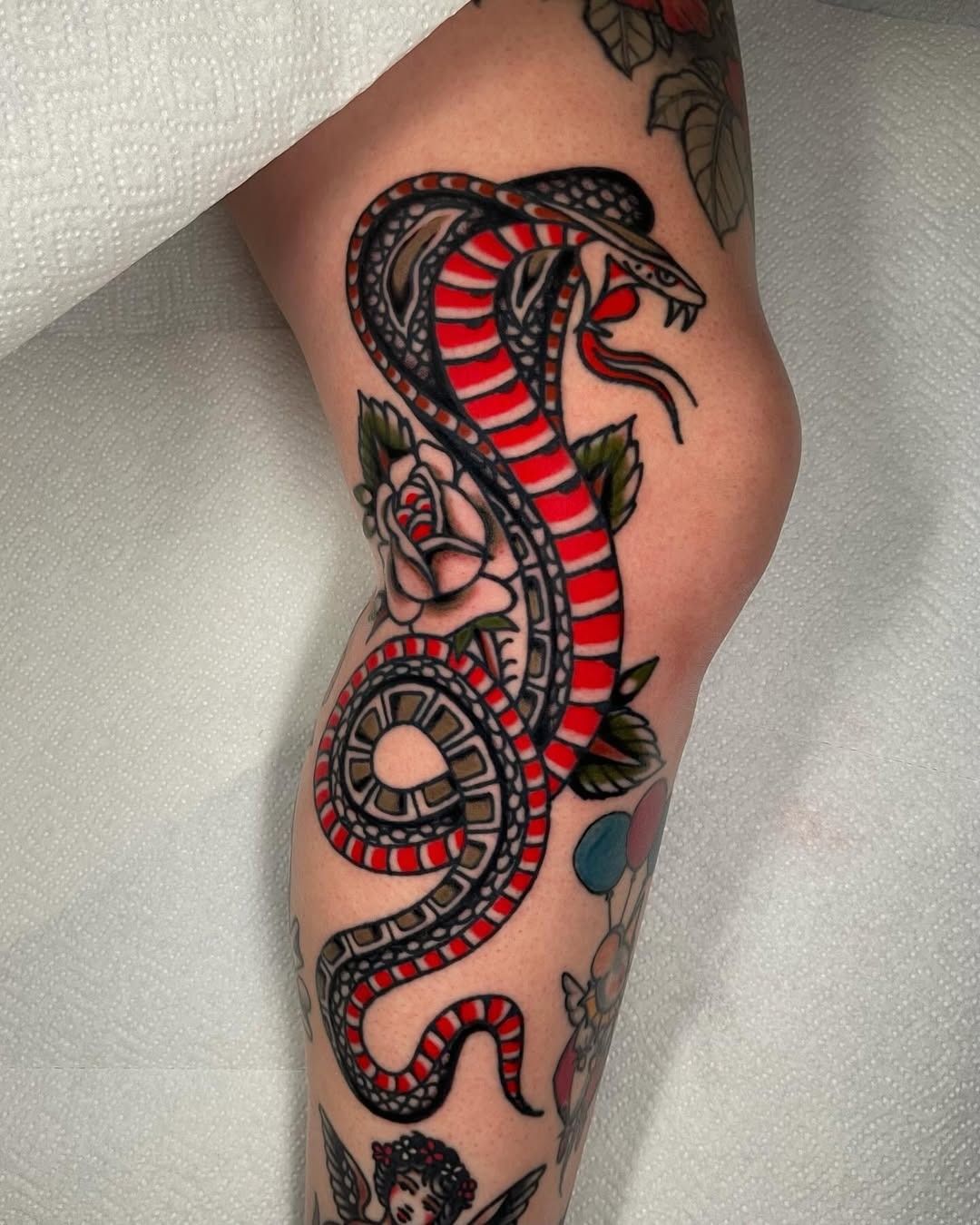 Bold snake tattoo with red and black design Tattoo Design
