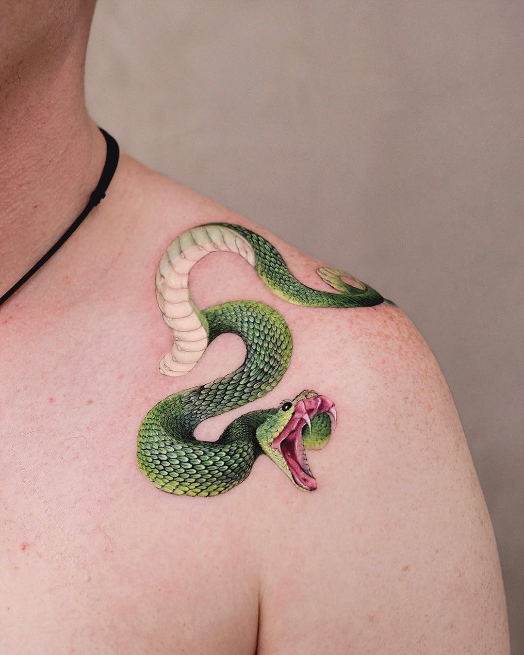 Dynamic green snake tattoo on shoulder Tattoo Design