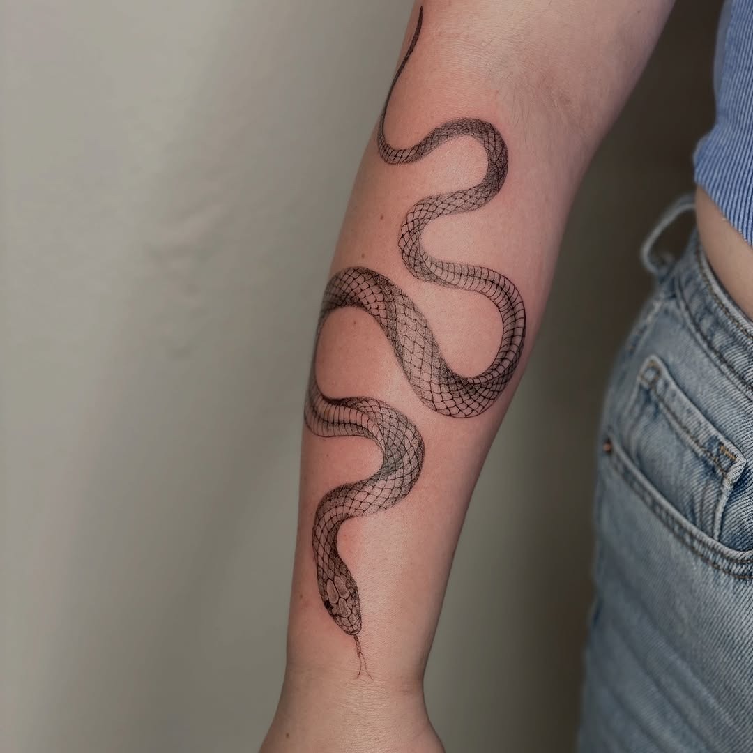 Elegant minimalist snake tattoo on forearm Tattoo Design